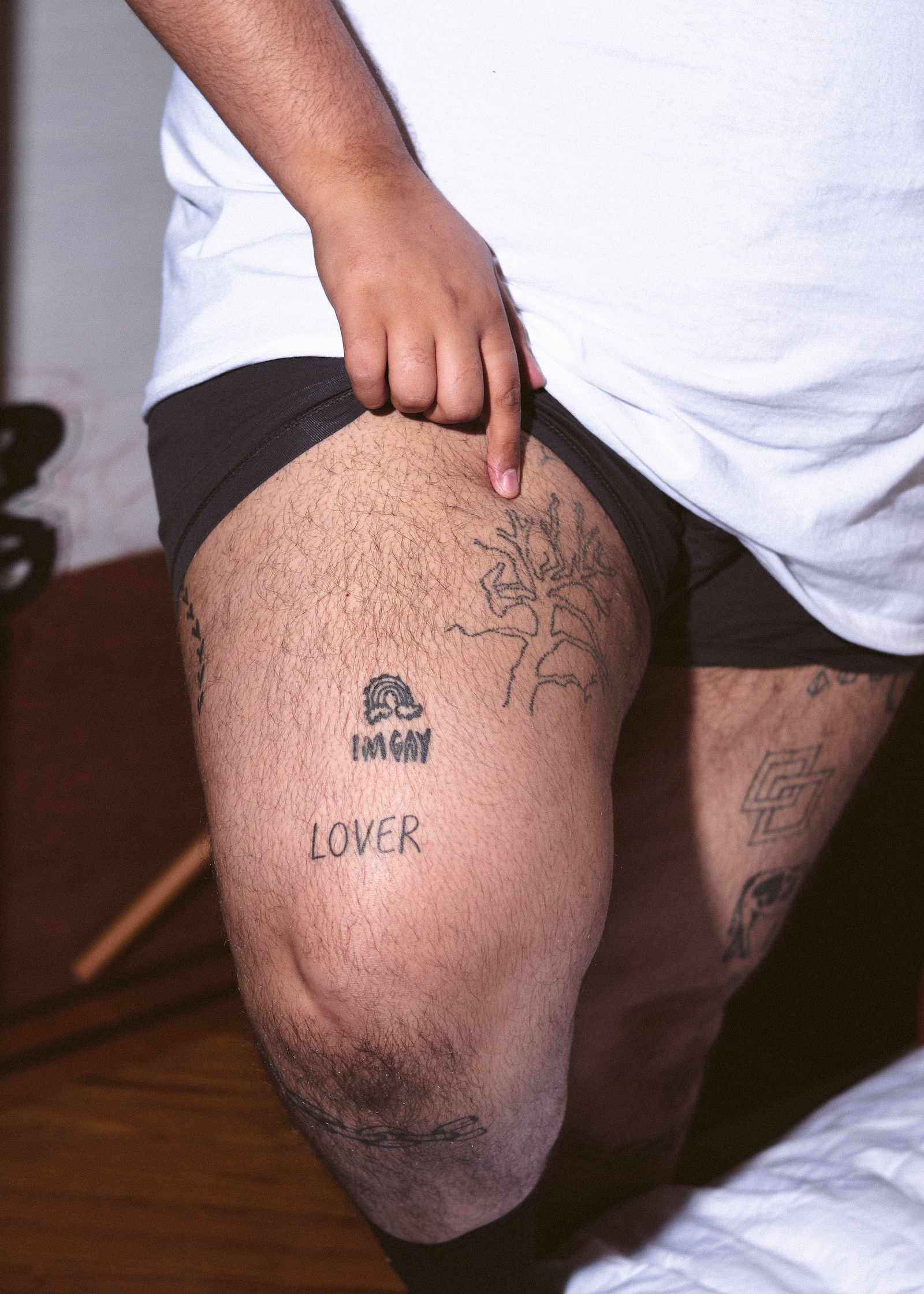 1635769645301 a transmasculine non binary person pointing out their tattoos 1 iMNH5K